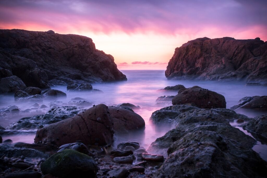 Asilah Beyond the Medina: Paradise Beach & the Arts Festival (2026 Guide) Dramatic rocky coastline at Asilah Paradise Beach, Morocco, at sunset