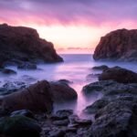 Asilah Beyond the Medina: Paradise Beach & the Arts Festival (2026 Guide) Dramatic rocky coastline at Asilah Paradise Beach, Morocco, at sunset