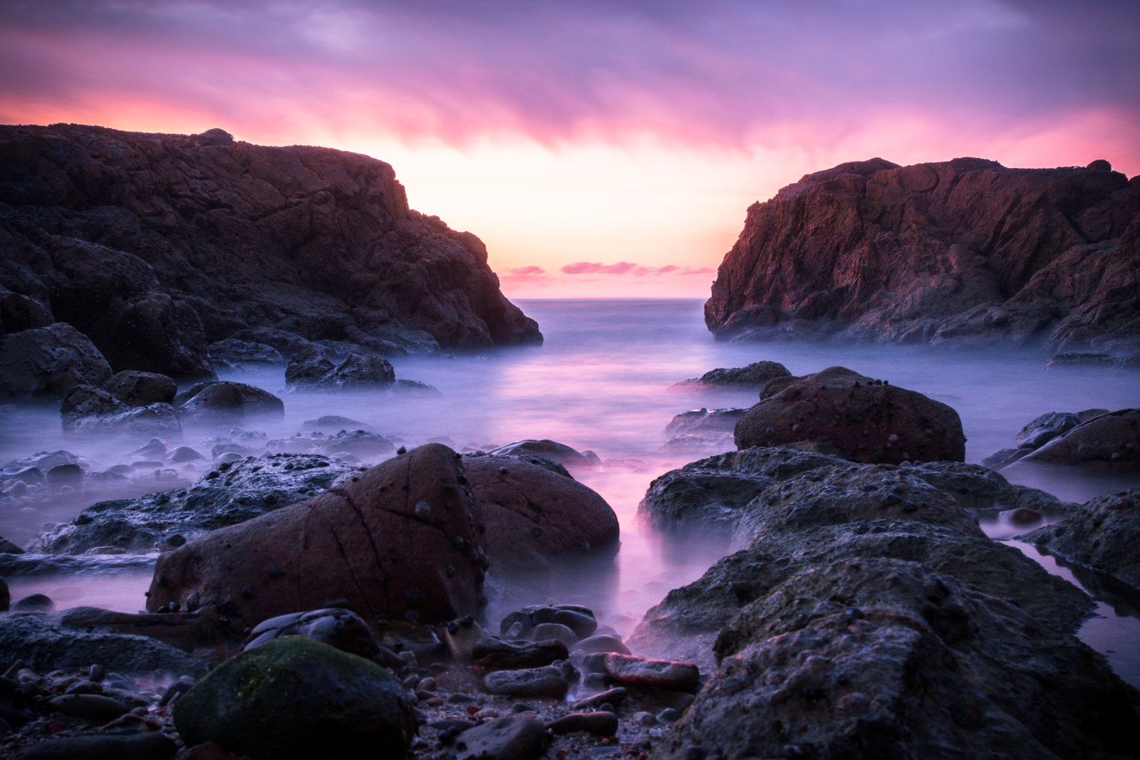Asilah Beyond the Medina: Paradise Beach & the Arts Festival (2026 Guide) Sunset over the rocky Atlantic coastline of Asilah, Morocco