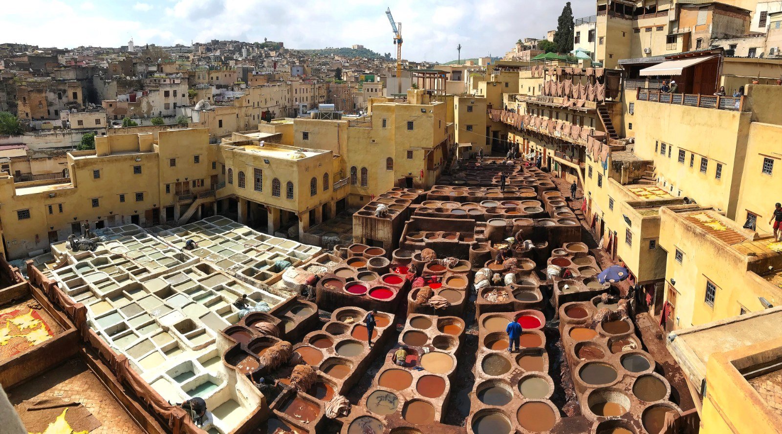 Fez Artisan Experiences: Rug Weaving, Wool Workshops & the Craft Souks (2026) Artisan craftsmanship in the medina of Fes, Morocco