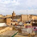 2 or 3 Days in Fes: What to Do, Where to Eat & How to Arrive (2026 Guide) Rooftop panorama of the Fes el-Bali medina, Morocco, with a minaret rising above the terraces